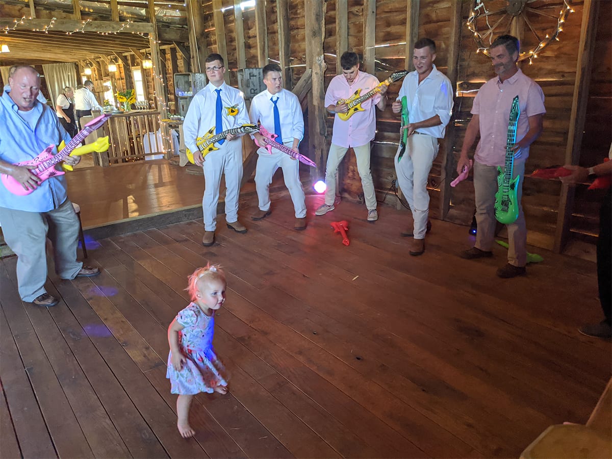 Group playing guitar with kid in the center Group playing guitar with kid in the center